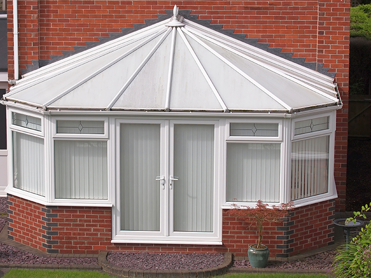 Picture of a conservatory with brick and upvc at rear of a home