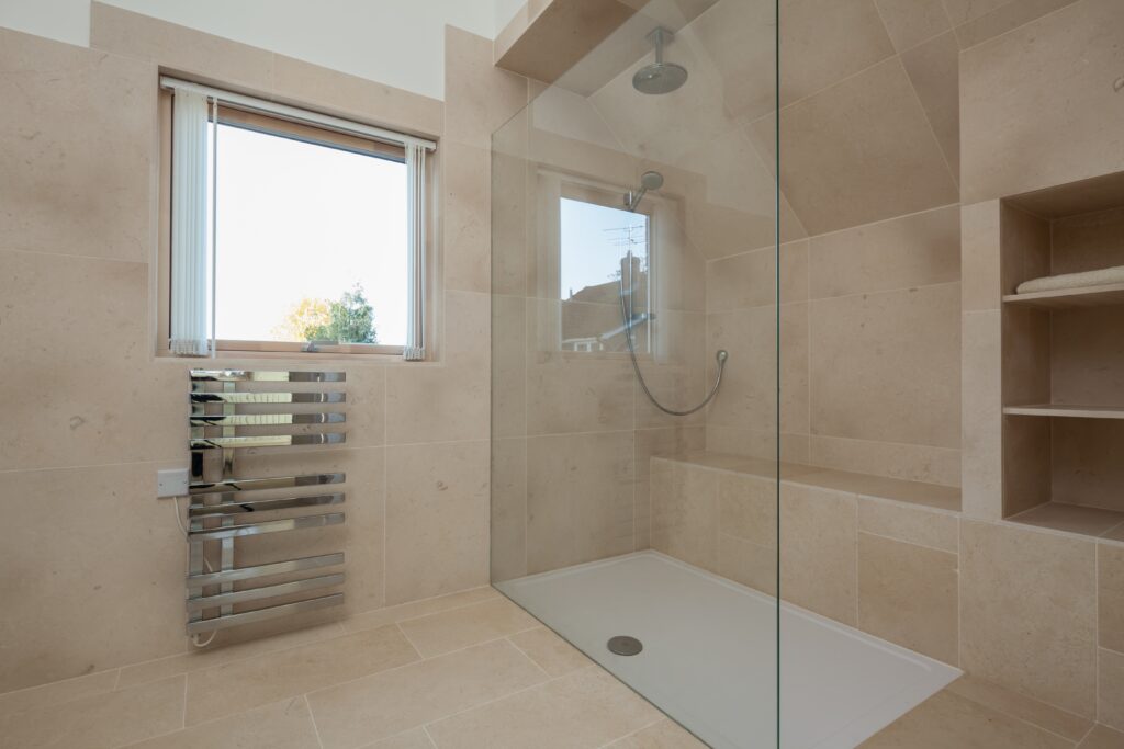 Picture of a walk-in shower in a bathroom with radiator