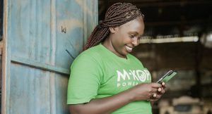 Woman in green T-shirt holding a smartphone